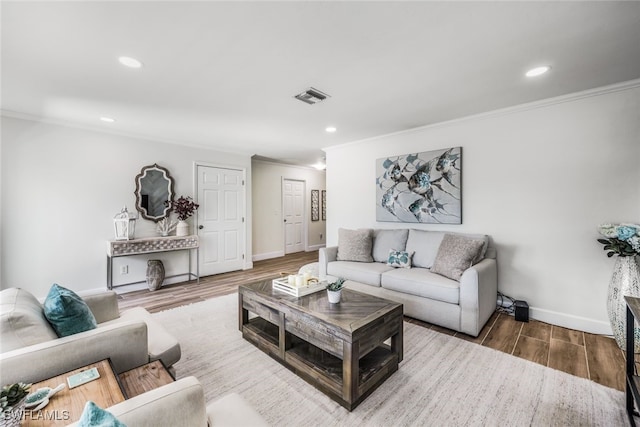 living room with wood-type flooring and ornamental molding