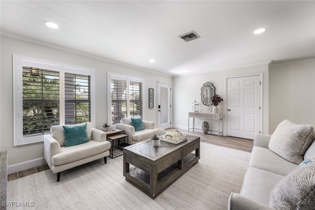 living room with crown molding and light hardwood / wood-style flooring