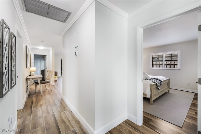 hall featuring hardwood / wood-style floors and crown molding