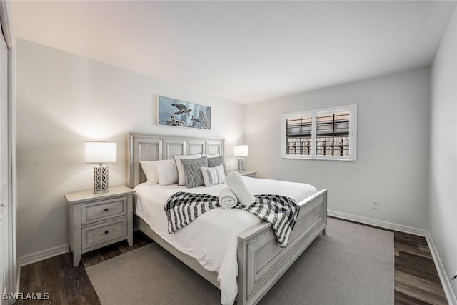 bedroom with dark wood-type flooring