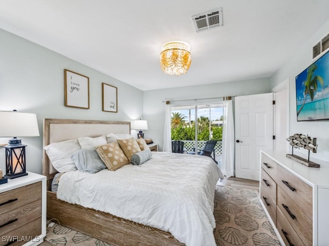 bedroom with access to outside and light hardwood / wood-style floors