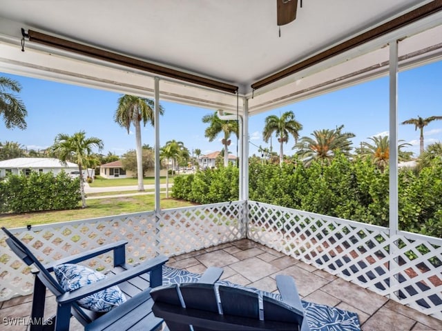 sunroom / solarium featuring ceiling fan