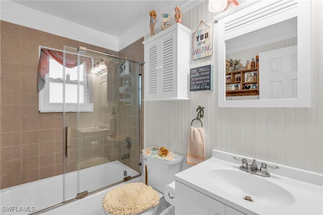 full bathroom with vanity, toilet, and enclosed tub / shower combo