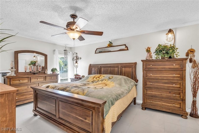 bedroom with ceiling fan and a textured ceiling