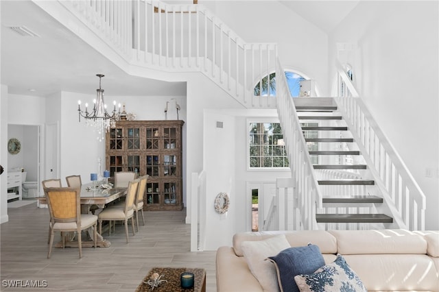 living room with a chandelier and a towering ceiling