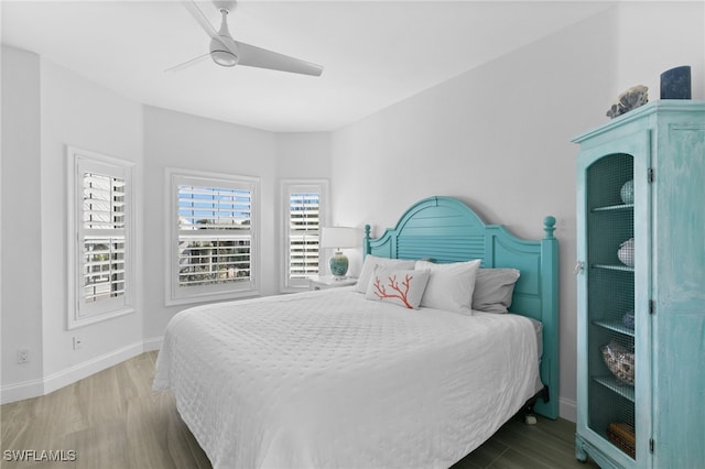 bedroom with hardwood / wood-style floors and ceiling fan