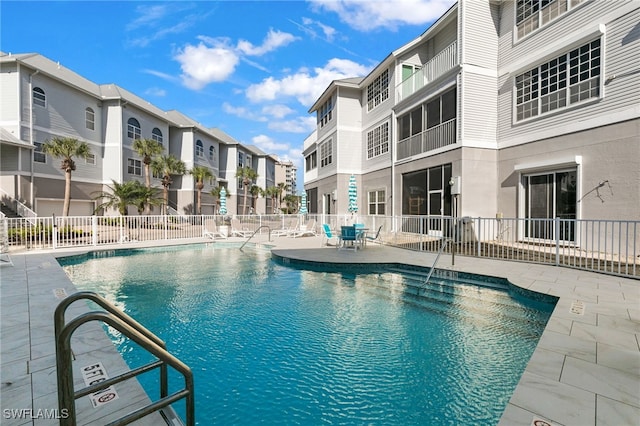 160 Barefoot Cir Unit 38, Bonita Springs, FL 34134 - community pool featuring a patio, fence, and a residential view