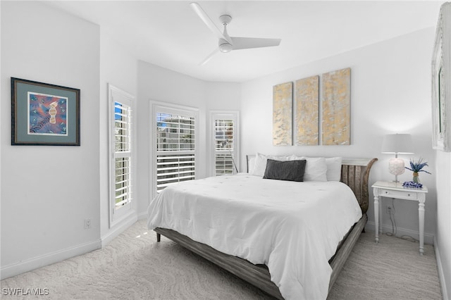 bedroom featuring ceiling fan and light carpet