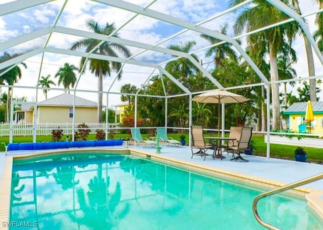 view of swimming pool featuring a lanai and a patio