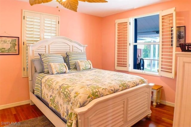 bedroom with ceiling fan and dark hardwood / wood-style floors