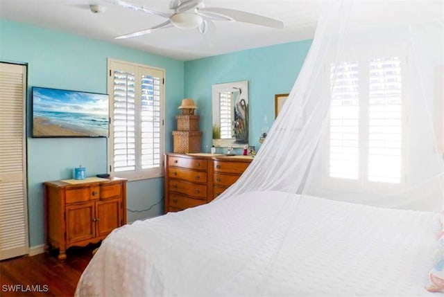 bedroom with ceiling fan and dark wood-type flooring