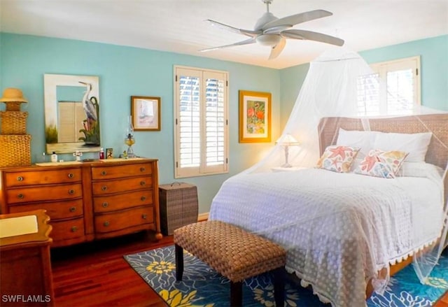 bedroom featuring ceiling fan and dark wood-type flooring