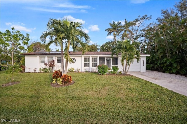 ranch-style home featuring a front lawn and a garage