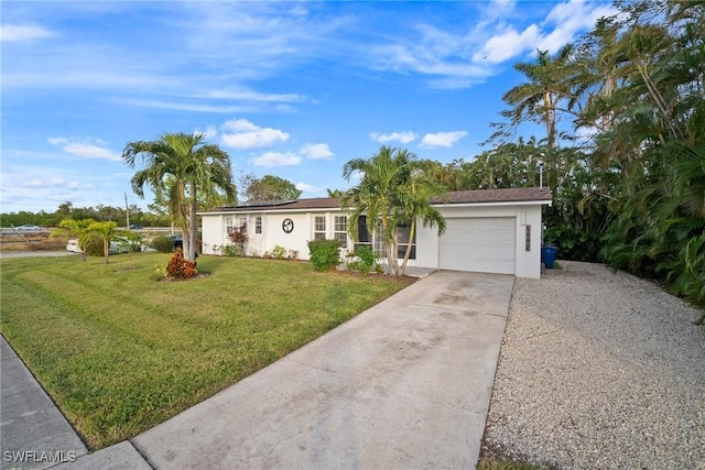 ranch-style house featuring a garage and a front lawn