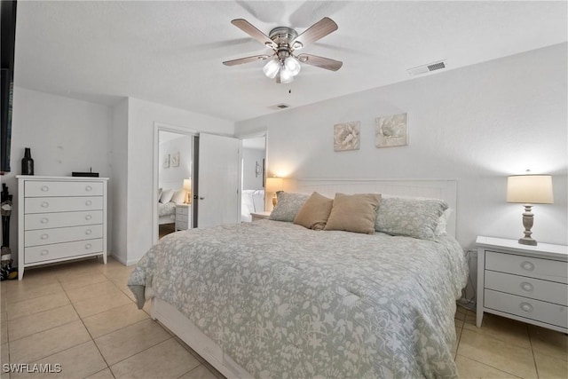 bedroom with ceiling fan and light tile patterned floors