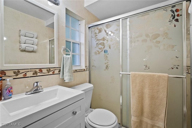 bathroom featuring vanity, an enclosed shower, and toilet