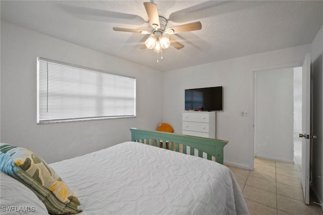 bedroom featuring light tile patterned floors, a textured ceiling, and ceiling fan