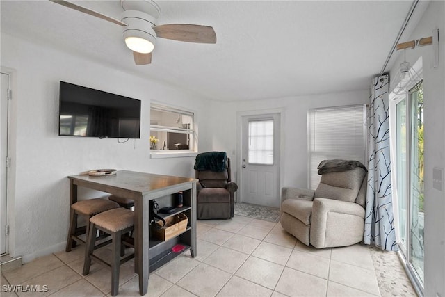 tiled living room featuring ceiling fan