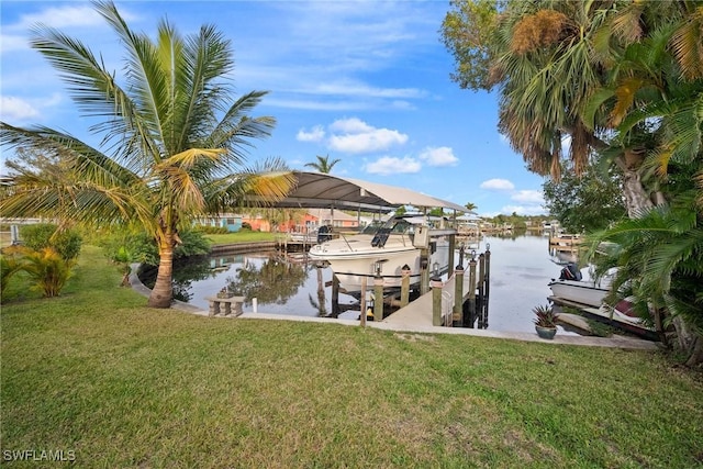 view of dock with a water view and a yard