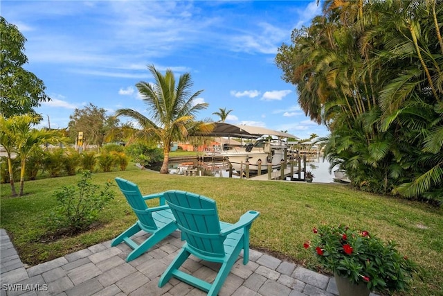 exterior space featuring a water view, a dock, and a lawn