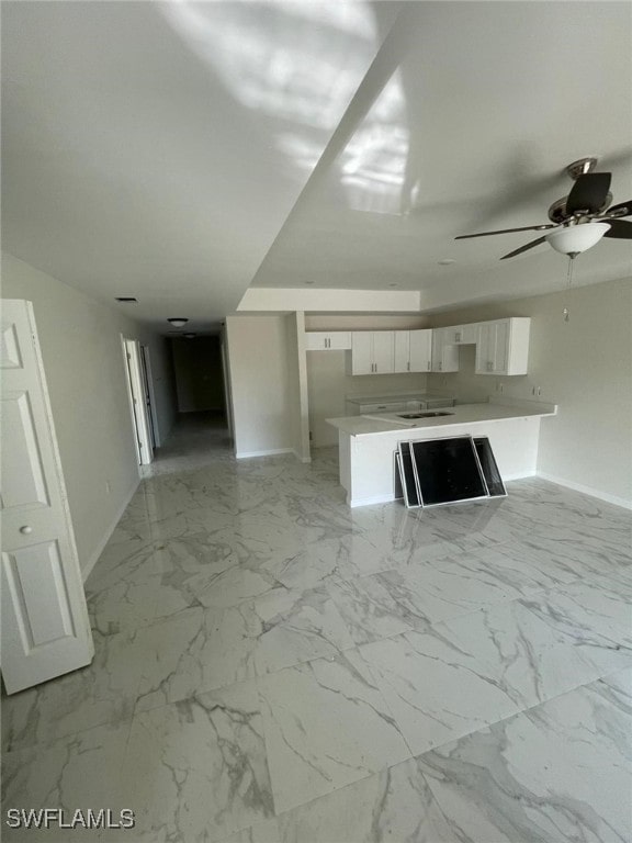 unfurnished living room featuring ceiling fan