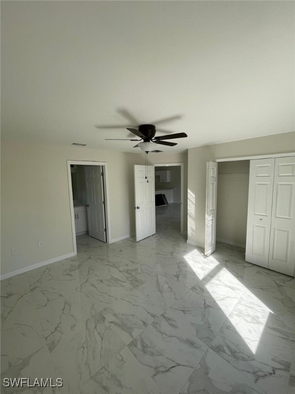 interior space featuring ceiling fan and a closet