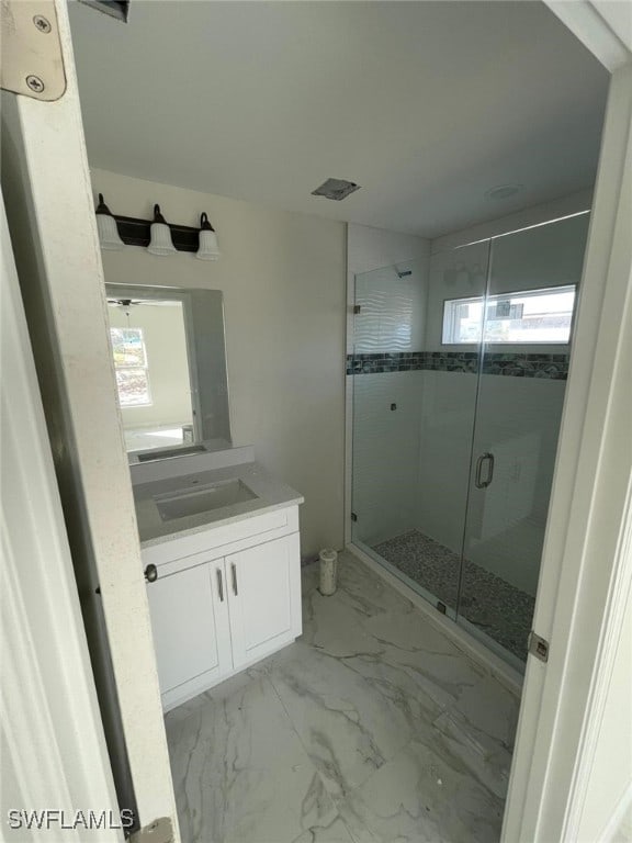 bathroom with vanity and a shower with shower door