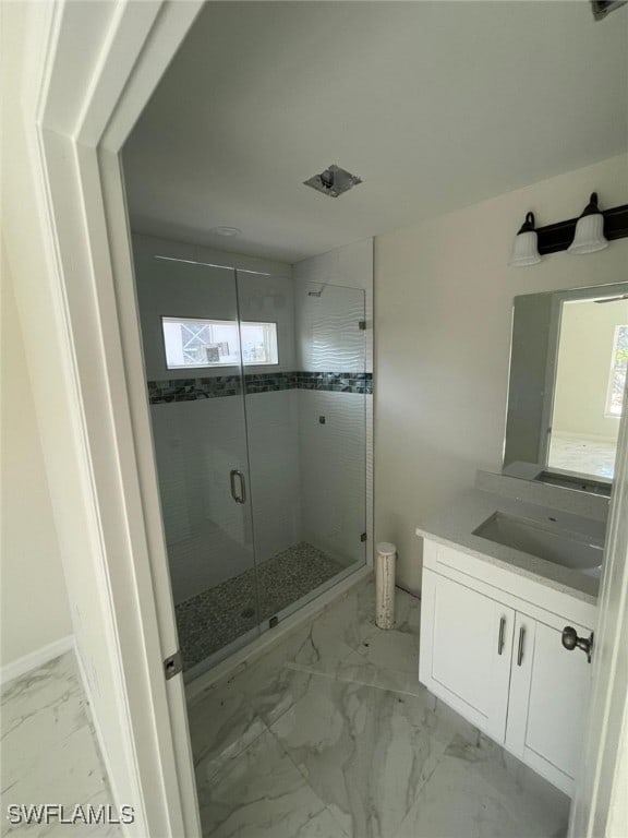 bathroom with vanity and a shower with shower door