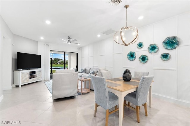 tiled dining room featuring ceiling fan with notable chandelier