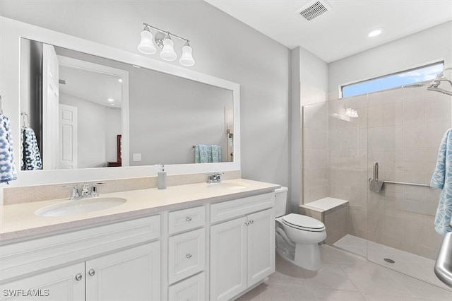 bathroom featuring toilet, tile patterned flooring, vanity, and walk in shower