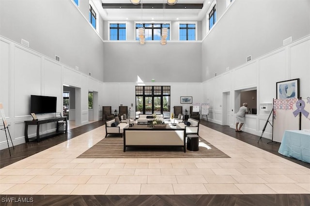 living room with a high ceiling and light hardwood / wood-style floors