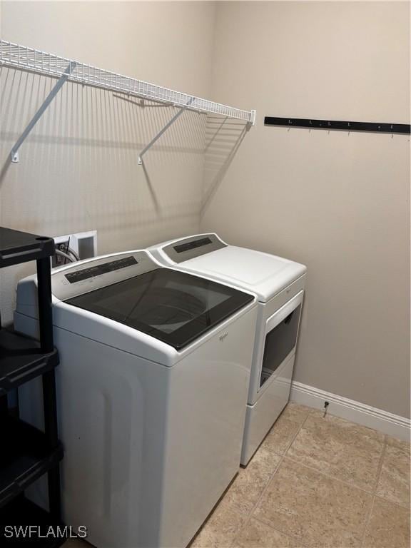 clothes washing area with washing machine and dryer