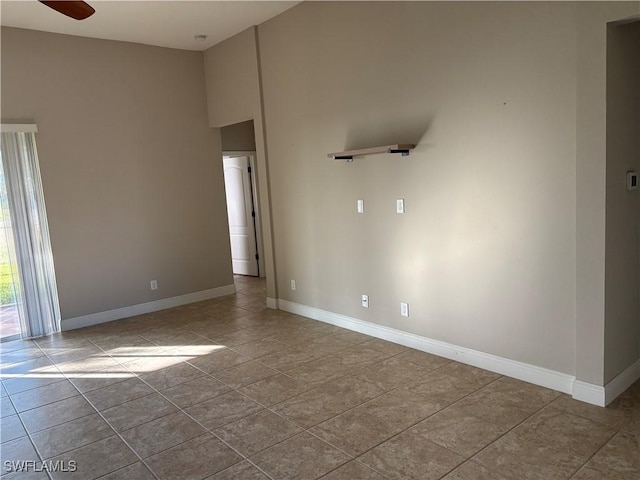 unfurnished room featuring light tile patterned flooring and ceiling fan