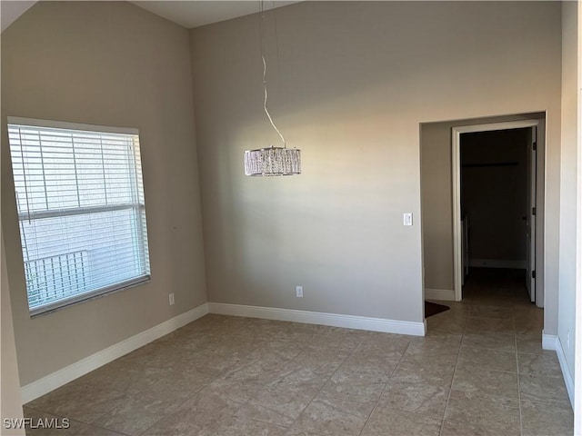 unfurnished room with a high ceiling