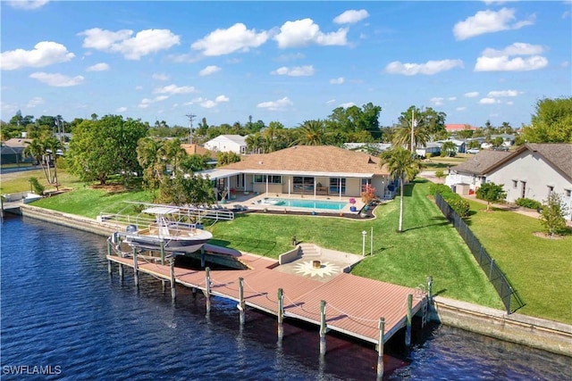 view of dock featuring a yard, a water view, and a patio