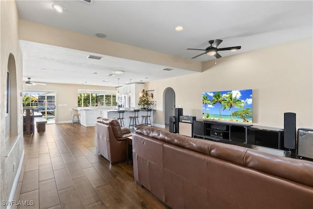 living room featuring ceiling fan and hardwood / wood-style flooring