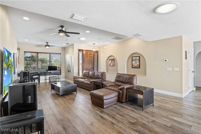 living room featuring ceiling fan and wood-type flooring