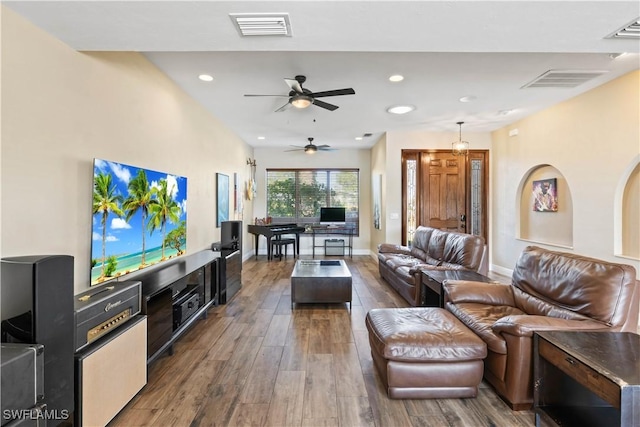 living room featuring hardwood / wood-style floors and ceiling fan