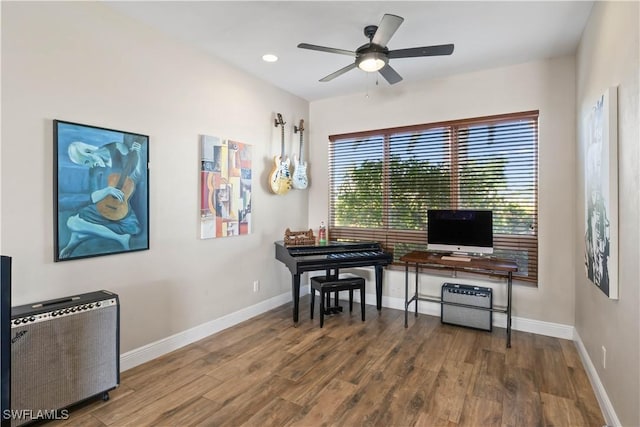 office area featuring radiator, ceiling fan, and hardwood / wood-style flooring