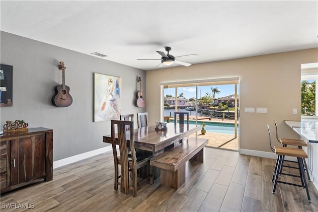 dining room with light hardwood / wood-style floors and ceiling fan