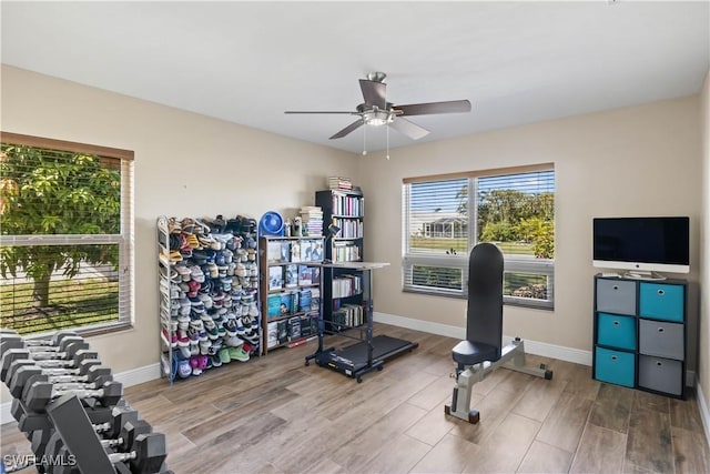 workout room with wood-type flooring and ceiling fan