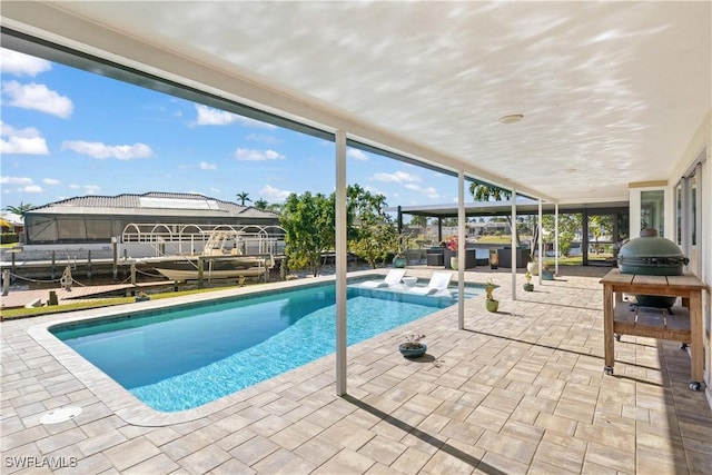 view of pool featuring a boat dock, a grill, an outdoor hangout area, and a patio