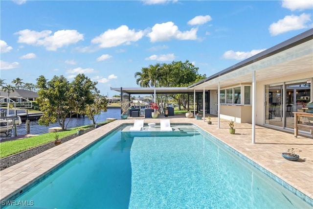 view of swimming pool with a patio and a water view