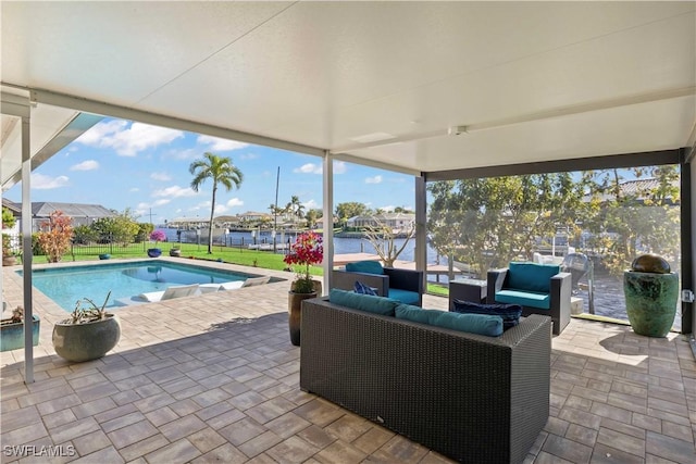 view of swimming pool featuring a patio area, a water view, and an outdoor hangout area