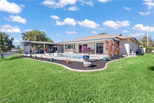 back of house with a patio area and a lawn