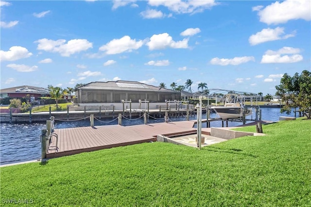 view of dock with a water view and a lawn