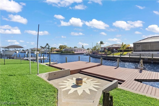 dock area featuring a lawn and a water view