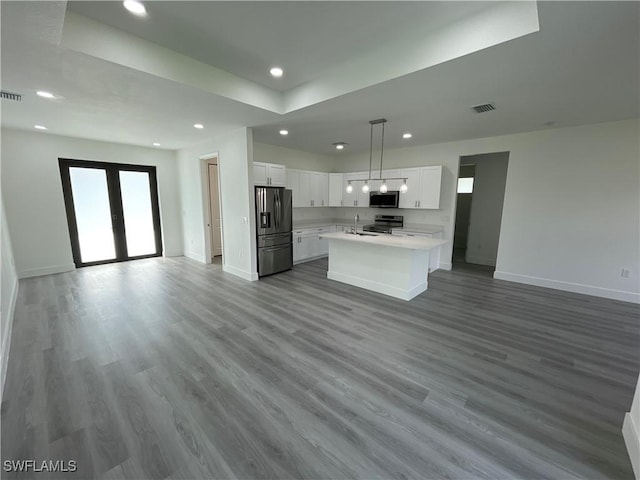 kitchen featuring sink, appliances with stainless steel finishes, white cabinetry, hanging light fixtures, and french doors