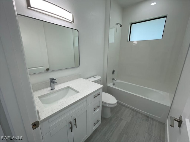 full bathroom with vanity, shower / tub combination, and toilet