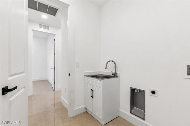 washroom featuring electric dryer hookup and sink